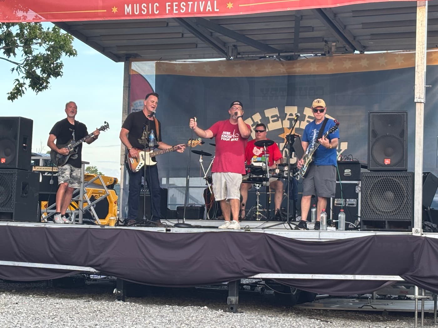 PHEVE performing as a five-piece on the outdoor stage at the Kenton County Fair