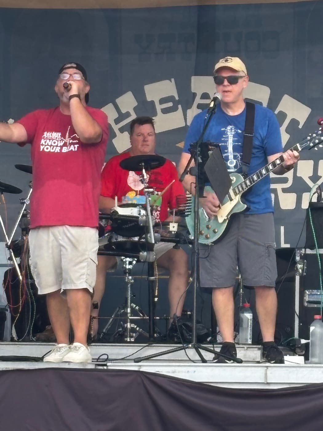 Singer and guitarist in front of the festival backdrop at the Kenton County Fair