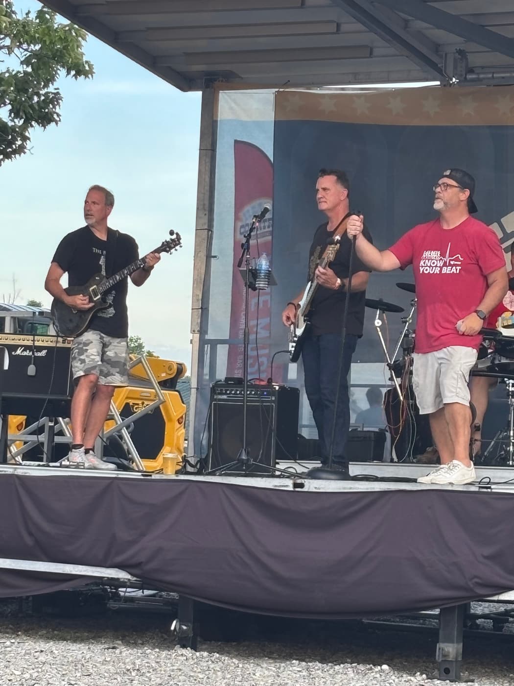 Guitarist, bassist, and singer playing the Kenton County Fair stage