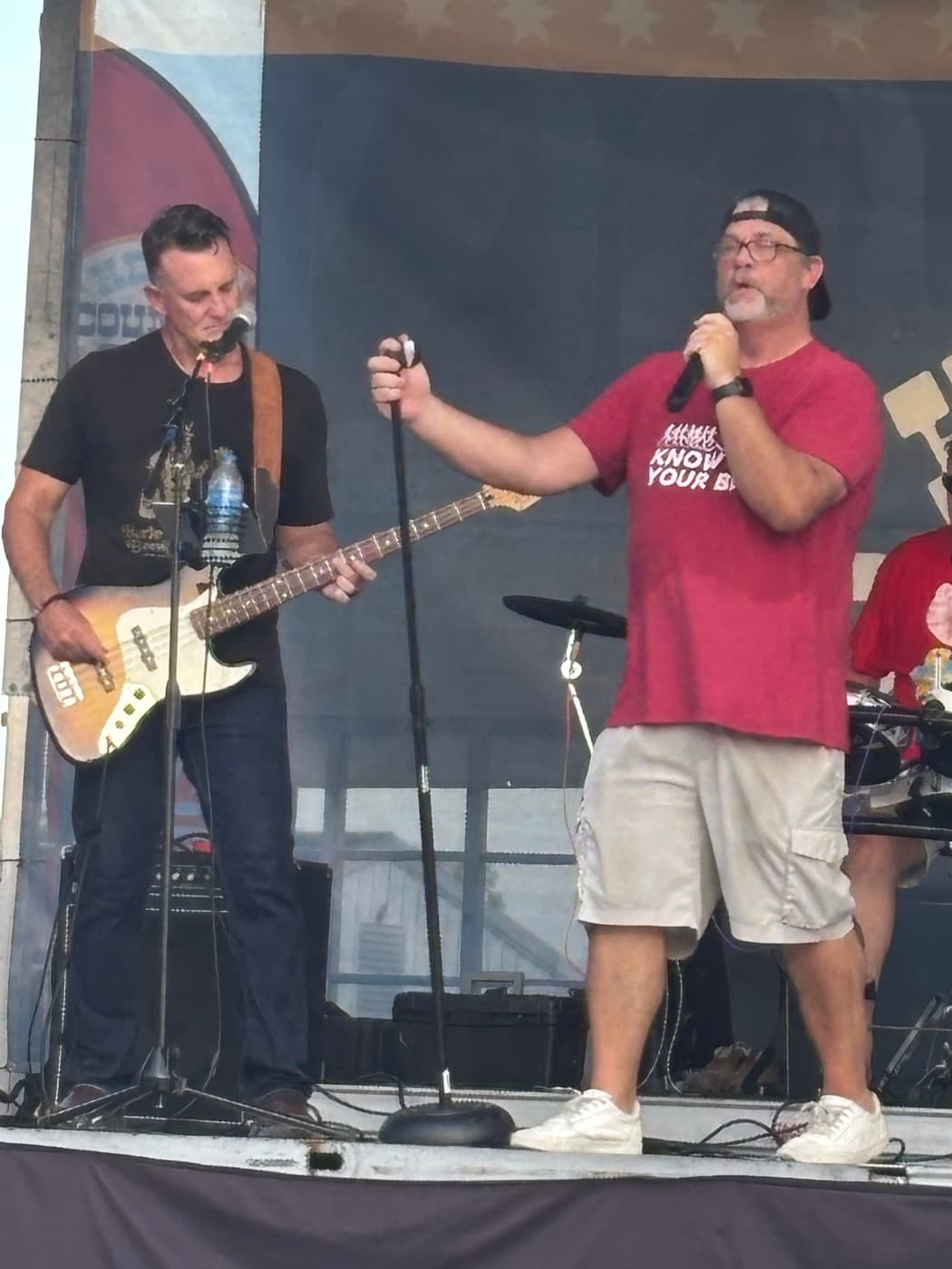 Bassist and singer at the mic stand during the Kenton County Fair set