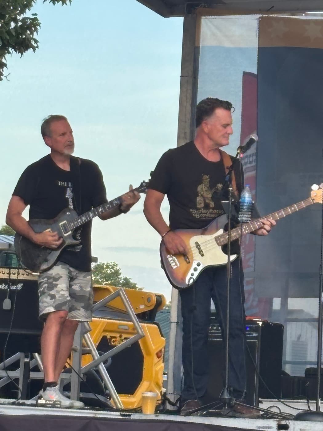 Guitarist and bassist playing in afternoon light at the Kenton County Fair